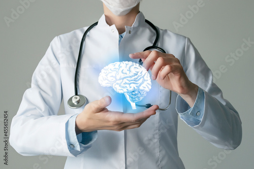 Neurologist doctor, brain specialist. Aesthetic handdrawn highlighted illustration of human brain. Neutral grey background, studio photo and collage. photo