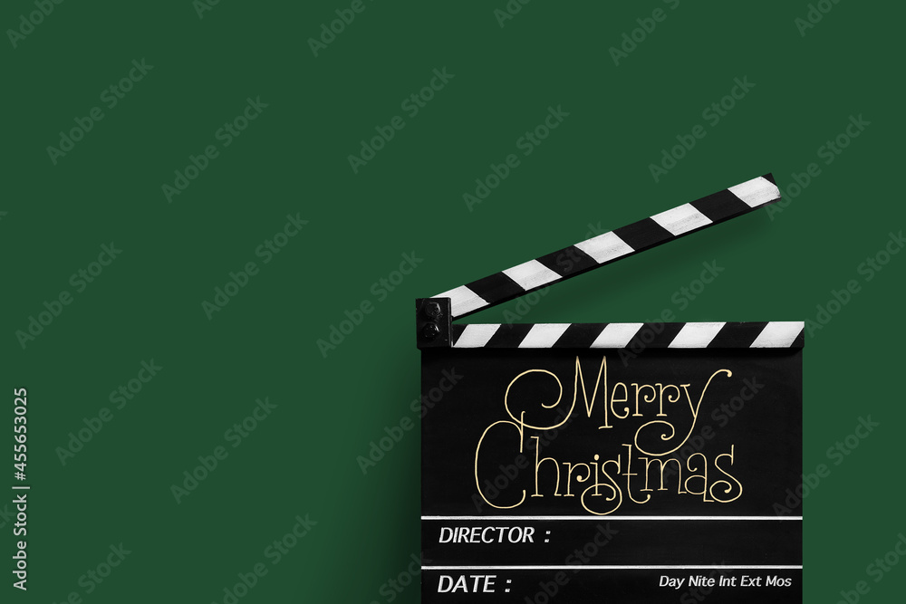 Naklejka premium Merry Christmas, Handwriting on film slate.Green background.