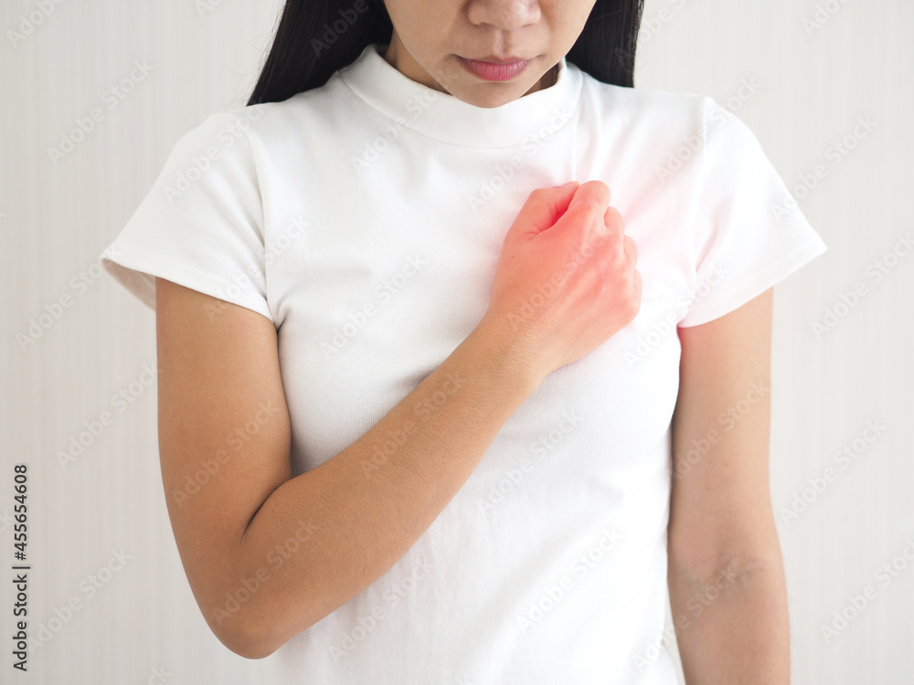 A woman suffering from chest pain on white background health care and heart disease concept. closeup photo, blurred. A woman suffering from chest pain on white background health care and heart disease concept. closeup photo, blurred.