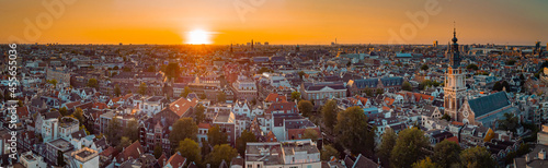 Photography Beautiful evening panorama of Amstedam city looking towards the west with beautiful sunset and sun setting down over Amsterdam