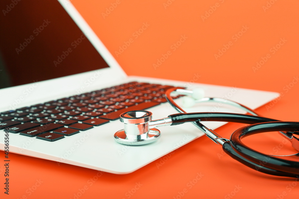stethoscope on a laptop on a color background close up. online medicine concept. computer repair concept. stethoscope on a laptop on a color background close up. online medicine concept. computer repair concept.