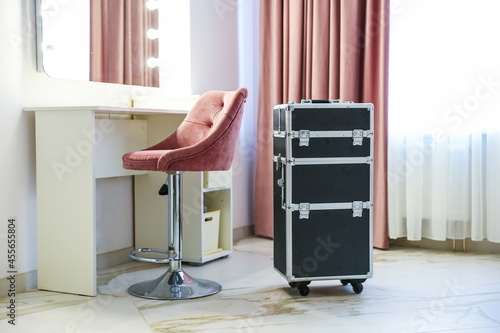 make up artist trolley case is in dressing room near the vanity mirror  photo