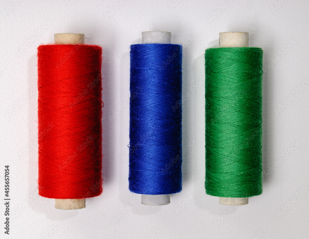 threads red blue green on white background threads red blue green on white background