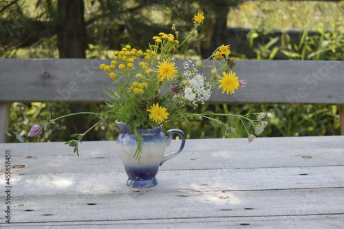 vase with flowers on the table in the garden