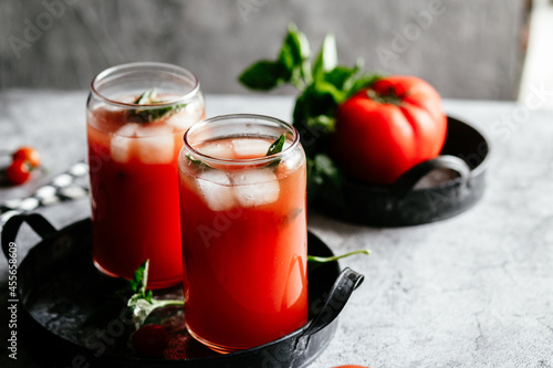 Wallpaper Mural Tomato juice with ice in a glass on a gray background Torontodigital.ca