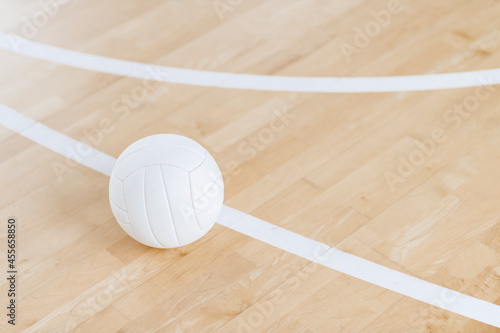 Volleyball ball and white line on wooden court. Horizontal education and sport poster, greeting cards, headers, website © Augustas Cetkauskas
