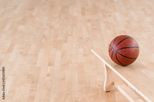 Brown basketball ball on bench. Horizontal education poster, greeting cards, headers, website © Augustas Cetkauskas