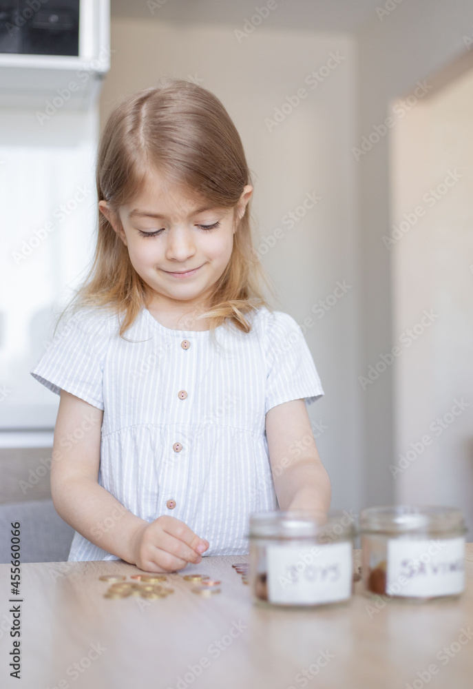 Little girl counting her savings. Little girl counting her savings.