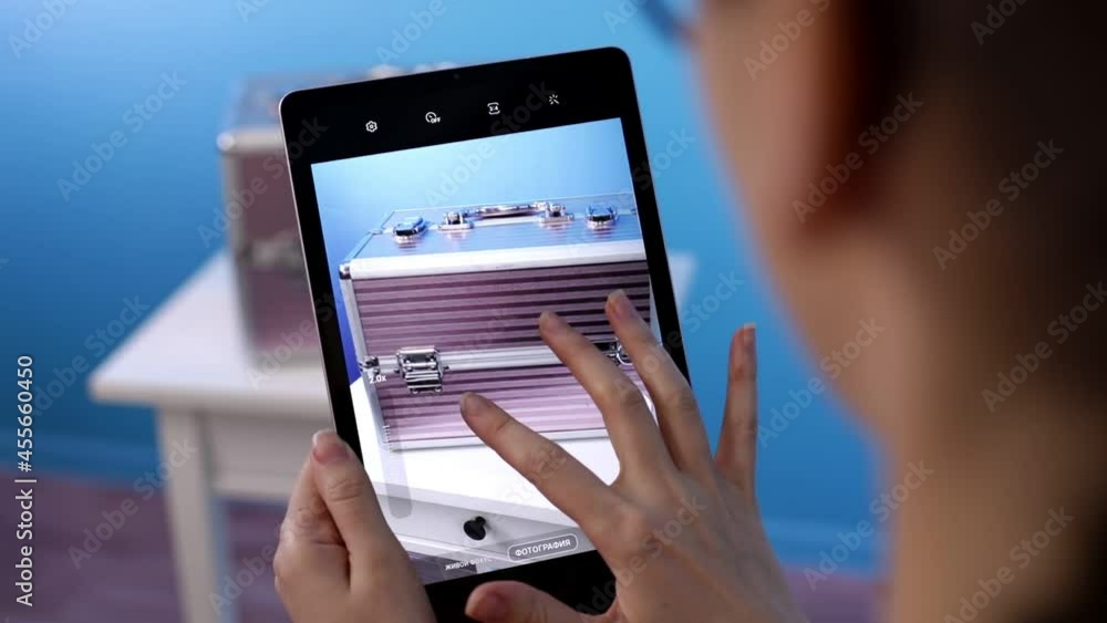 Female hands take pictures of the chest on a tablet. Female hands take pictures of the chest on a tablet.