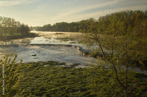 River Venta waterfall in sunny, misty spring morning, Kuldiga, Latvia.