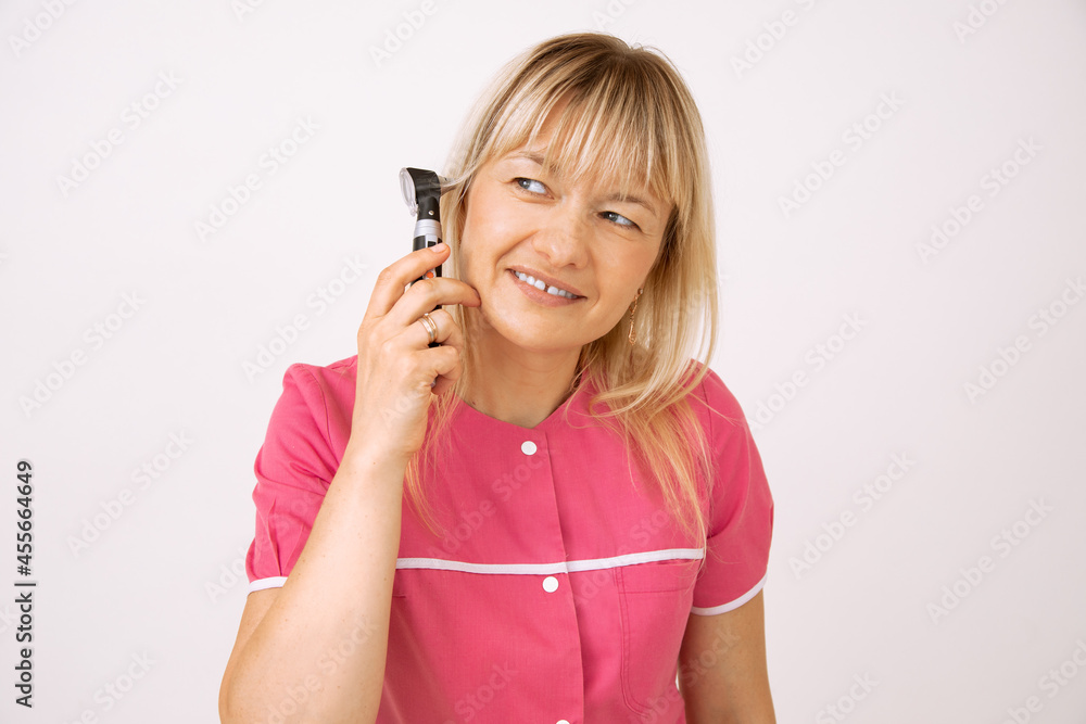 Attractive blonde doctor demonstrates equipment for examining ear. Modern medical equipment. Otolaryngologist. Medical examination. Latest technologies. Preventive examination.