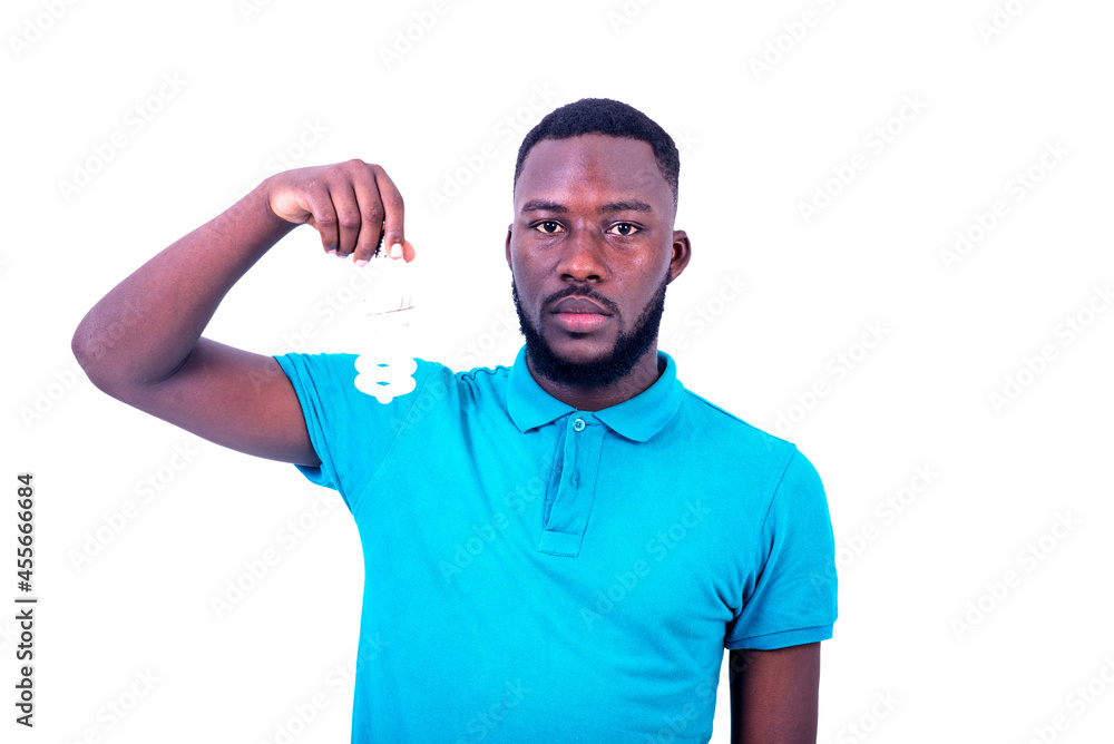 handsome serious young man holding a light bulb. handsome serious young man holding a light bulb.
