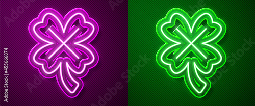 Glowing neon line Casino slot machine with clover symbol icon isolated on purple and green background. Gambling games. Vector