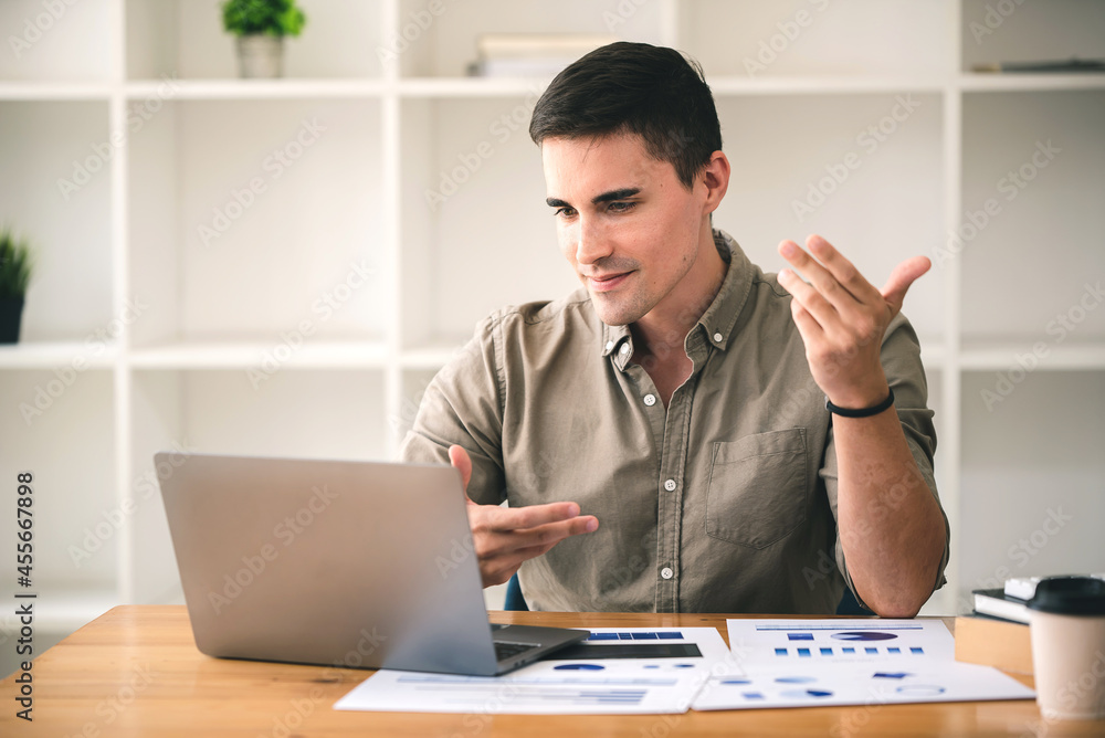 business man happily discussing work through laptop business man happily discussing work through laptop