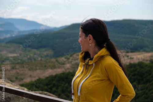 Young woman enjoy a mountain view from the top