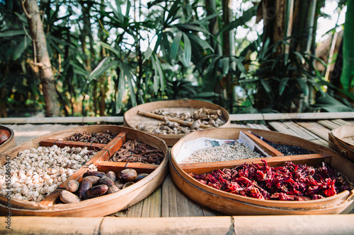 Traditional Indonesian - Balinese spices such as ginger, aniseed, cinnamon, nutmeg, roselle, cacao, vanilla, coriander seeds, turmeric on wooden trays