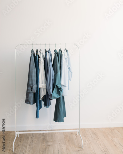 Rack with capsule clothes in blue colors