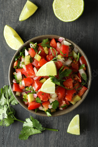 Mexican food concept with Pico de Gallo on dark wooden table