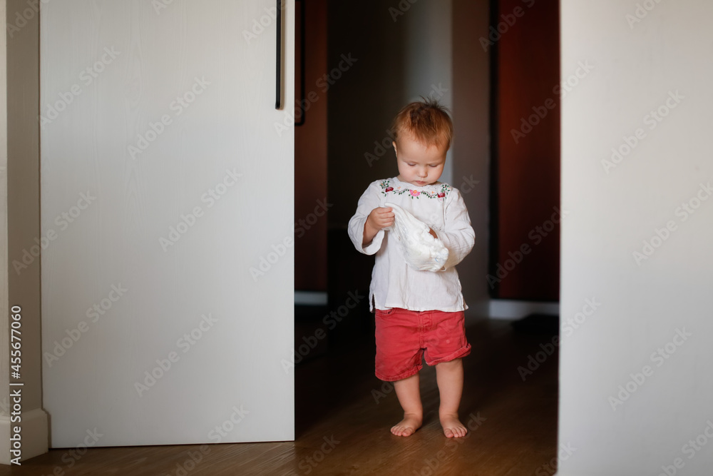 Toddler child with a diaper. in the apartment, soft focus and evening light. children's independence Toddler child with a diaper. in the apartment, soft focus and evening light. children's independence