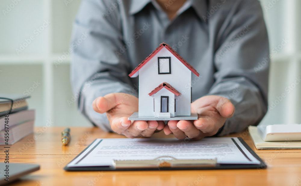 Property investment concept, image of small house model on the table.and home loan insurance. Property investment concept, image of small house model on the table.and home loan insurance.
