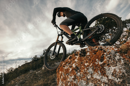 Man riding mountain bike in nature photo