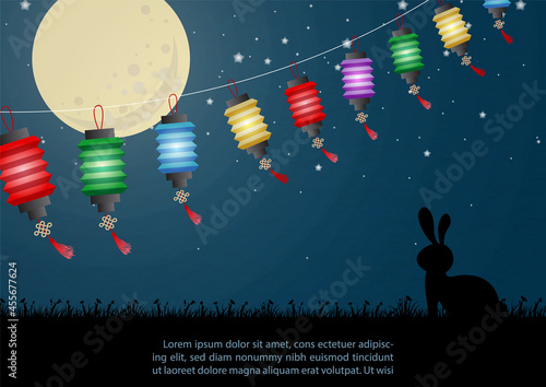 Colorful Chinese lanterns with silhouette rabbit standing make a wish with full moon in night time background. Chinese texts is meaning mid autumn festival in English