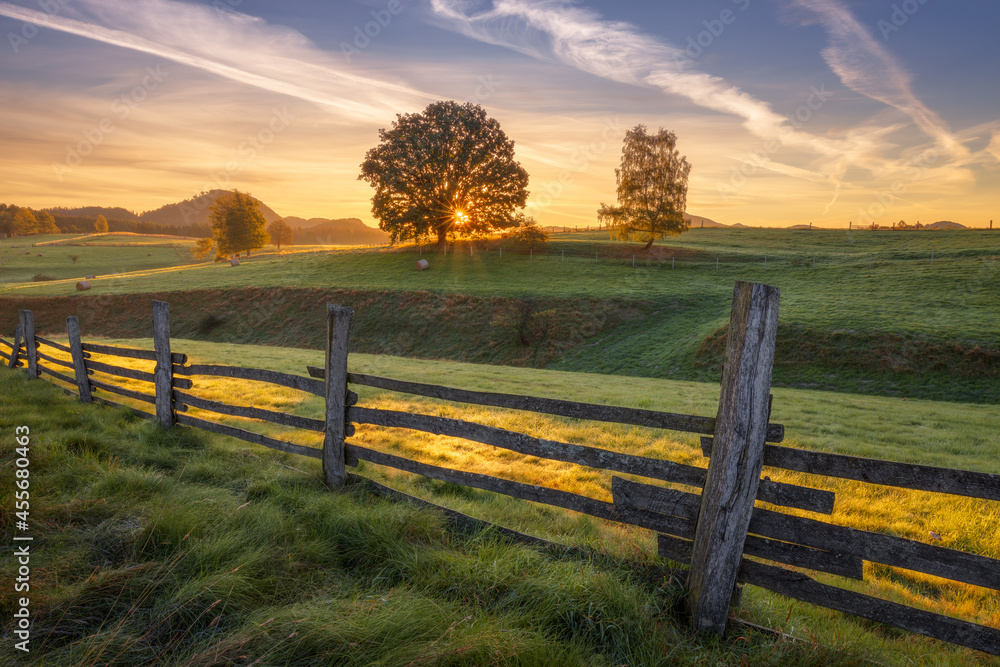Sunrise in landscape with fence