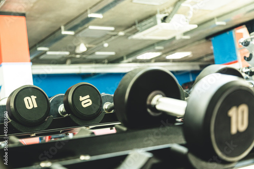 Dumbbells in the interior of the gym without people