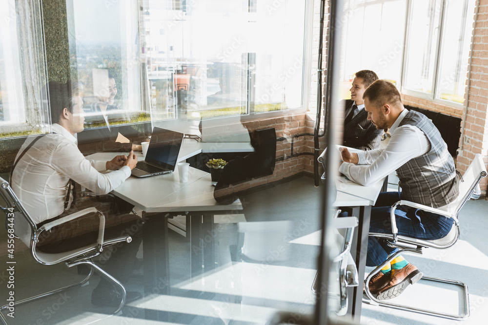 Group of young business people in smart casual wear working together in office. Team at work. Group of young business people in smart casual wear working together in office. Team at work.