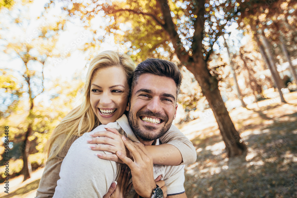 Boyfriend carrying his girlfriend on piggyback in autumn park. Boyfriend carrying his girlfriend on piggyback in autumn park.