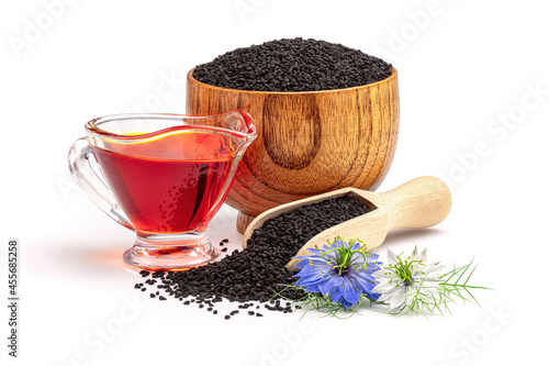 Konstfotografi Black cumin oil in gravy boat and nigella sativa flowers