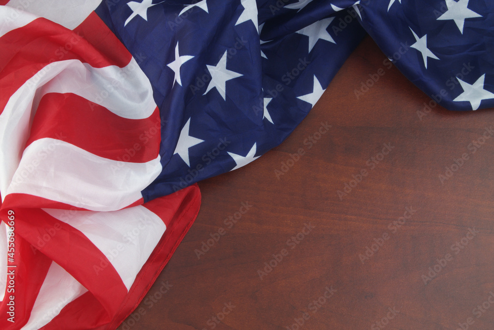 USA flag on wooden background. Close up of waved United States flag wit copy space for text. - obrazy, fototapety, plakaty 