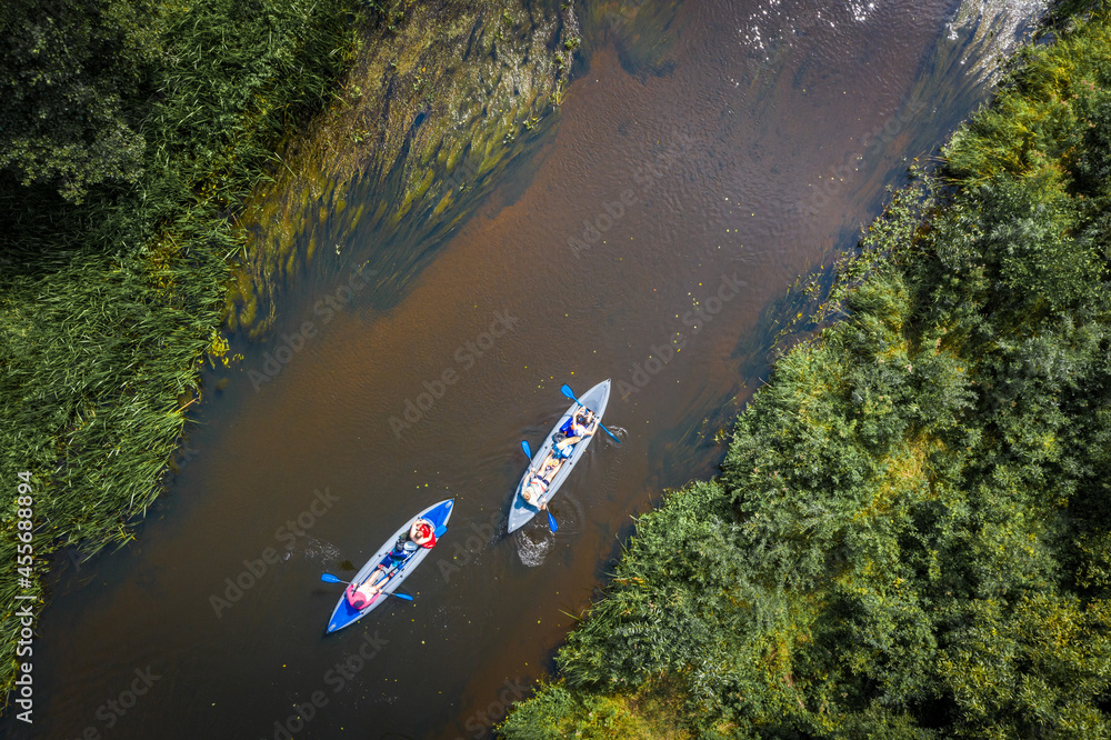 Travelling by kayaks on the river. Aerial view of kayaks on the river. Sport on the water. Rafting on the river kayaking with friends.