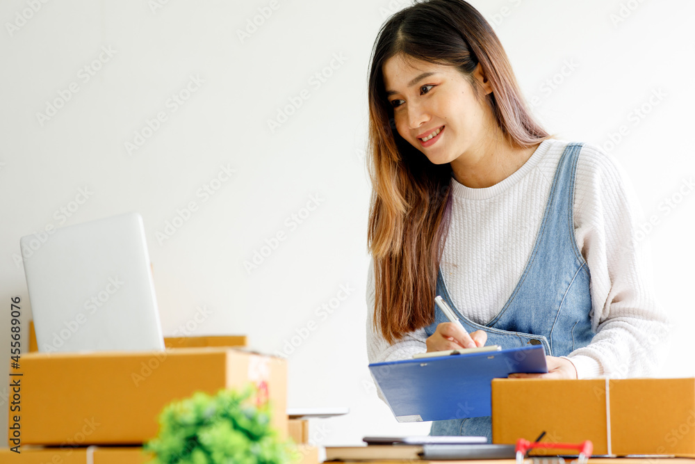 Portrait of businesswoman start small business and successful SME entrepreneurs A female works from home delivering parcels online ideas SME delivery and packaging concept. Portrait of businesswoman start small business and successful SME entrepreneurs A female works from home delivering parcels online ideas SME delivery and packaging concept.