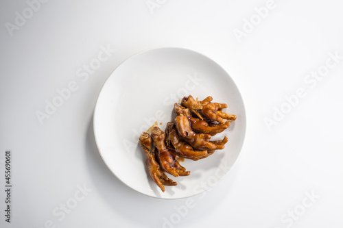 Chinese fried Chicken Feet on the plate isolated on white background