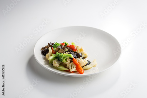 stir fry wok style mushroom, brocoli and cauliflower isolated on white background