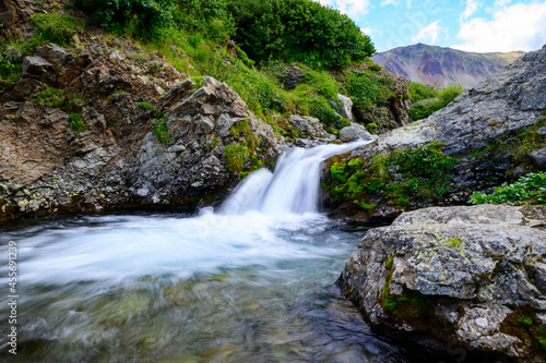 Landscape. A mountain river with clear and transparent water on the slope of the Vachkazhets volcano. Kamchatka Peninsula