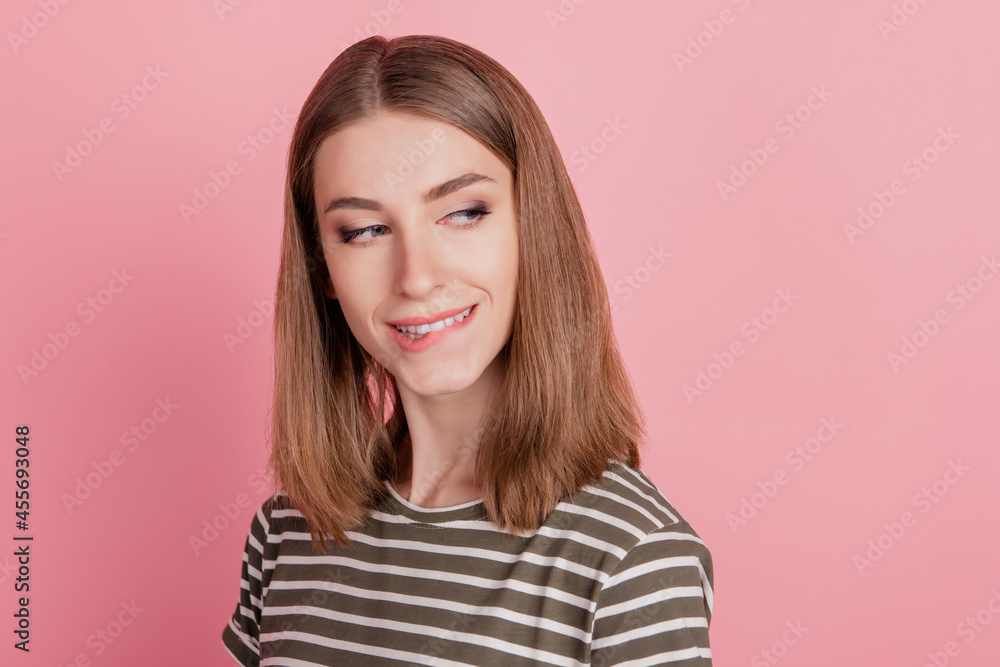 Portrait of tempting coquettish lady bite lip look blank space on pink background Portrait of tempting coquettish lady bite lip look blank space on pink background
