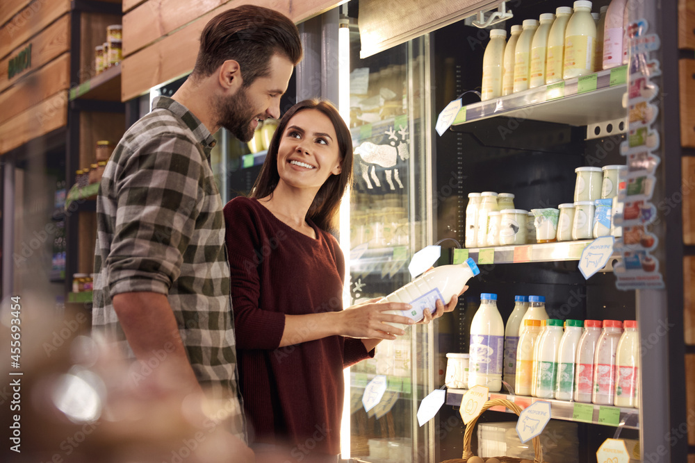 European couple choosing products in food store