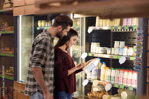 Couple watching information about milk on bottle