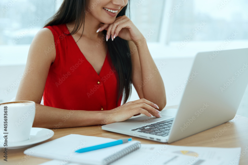 Business woman typing on laptop computer at desk Business woman typing on laptop computer at desk