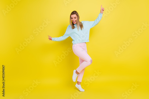 Full length body size view of pretty nice cheery girl dancing having fun isolated over bright yellow color background
