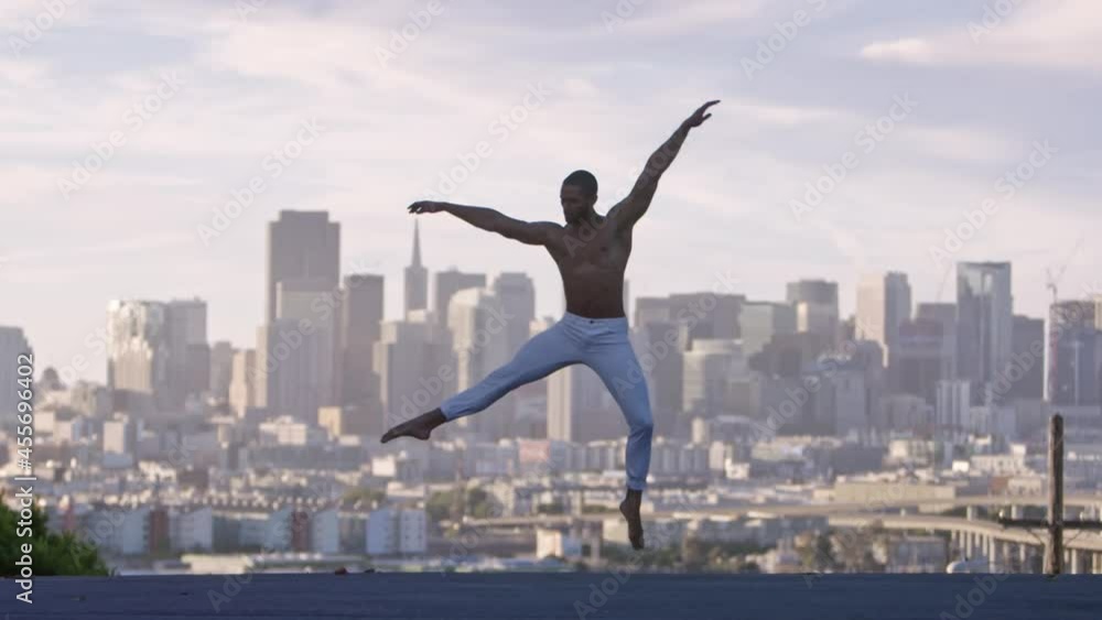 Graceful ballet dancer jumping and twirling in the air. San Francisco Graceful ballet dancer jumping and twirling in the air. San Francisco