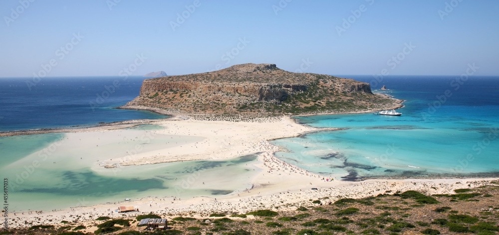 Balos lagoon with turquoise clear water with beautiful white sand beaches and Gramvousa island on Crete in Greece