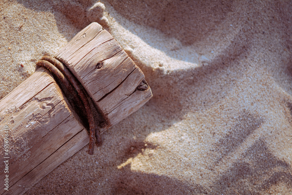 Wooden pillar on the sand with copy space