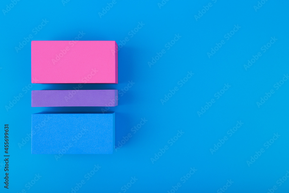 Flat lay with bisexual pride flag made of colorful blocks on blue background. Concept of lgbtq plus community, Pride month, sexual minorities and tolerance Flat lay with bisexual pride flag made of colorful blocks on blue background. Concept of lgbtq plus community, Pride month, sexual minorities and tolerance