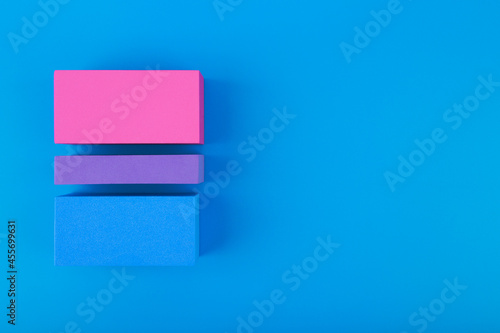 Flat lay with bisexual pride flag made of colorful blocks on blue background. Concept of lgbtq plus community, Pride month, sexual minorities and tolerance photo