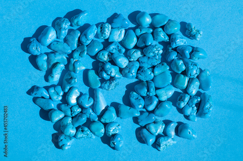 Turquoise jewel gemstones on blue background, group of objects