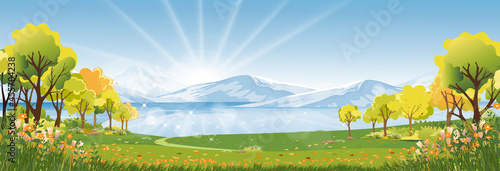 Spring landscape in city park in the morning, Natural public park with river, flowers blooming in the garden, Peaceful scene of green fields with lake and blue sky, cloudy in sunny day summer.