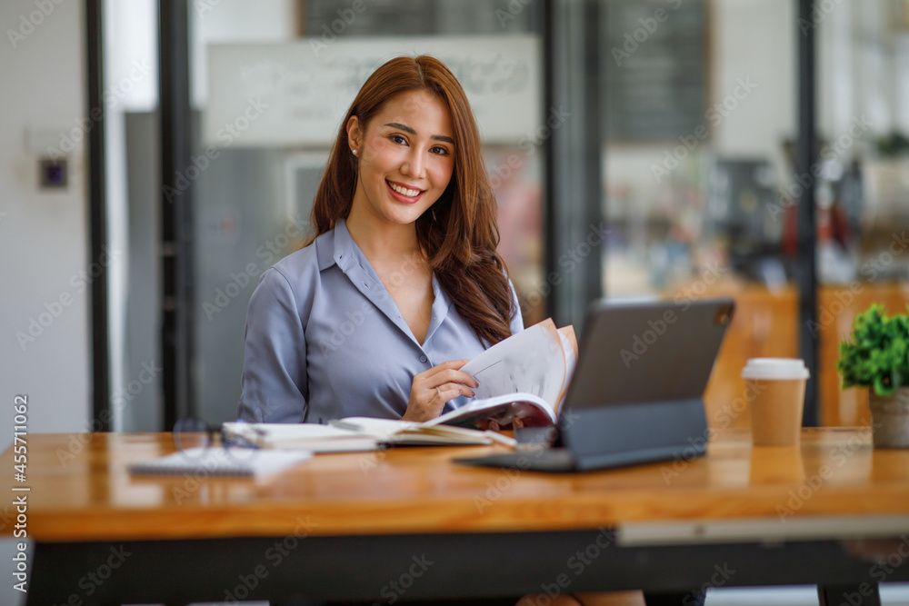 Portrait of smiling beautiful business asian woman with working in modern office desk using computer, Business people employee freelance online marketing e-commerce telemarketing concept. Portrait of smiling beautiful business asian woman with working in modern office desk using computer, Business people employee freelance online marketing e-commerce telemarketing concept.